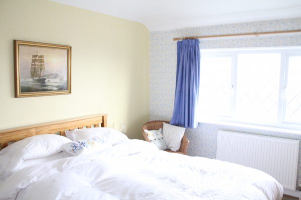 Bedroom 1 double bed beneath a bright window